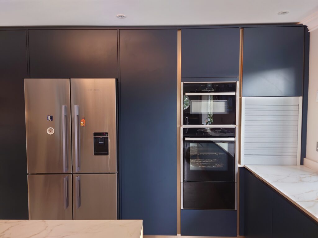 Handleless navy kitchen in West Chiltington